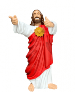 Estatueta de Jesus de braços abertos fazendo sinal de positivo